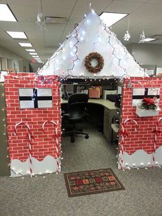 an office cubicle decorated for christmas with decorations on the front and side walls,