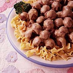 a white plate topped with pasta and meatballs