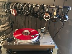 a turntable with headphones hanging on the wall