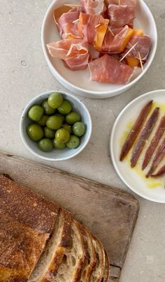 bread, olives, and other food items on a cutting board