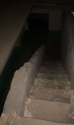 an old set of stone steps leading up to a dark room