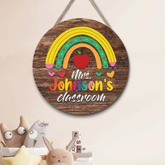 a wooden sign that says mr johnson's classroom with an apple and rainbow on it