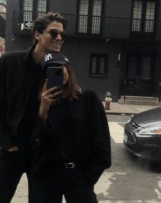 a woman taking a selfie with her cell phone on the street in new york city