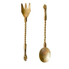 two gold utensils with twisted handles on each side, one holding a ball and the other holding a fork