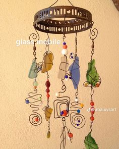 a wind chime hanging from the side of a wall