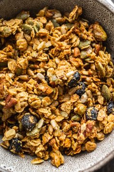 a bowl filled with granola sitting on top of a table