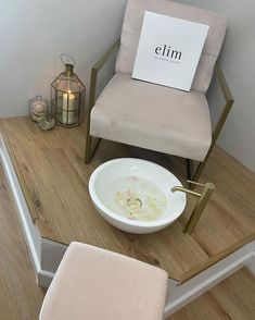 a chair sitting on top of a wooden floor next to a bowl