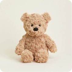 a brown teddy bear sitting up against a white background