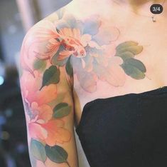 a woman's arm with flowers painted on it