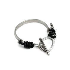 a silver ring with black cord and metal hooks