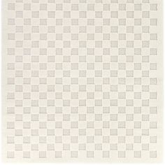 a white rug with checkered squares on the bottom, and a light gray background