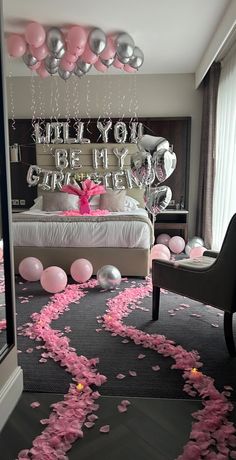 a bedroom decorated with balloons, streamers and confetti on the floor for a party