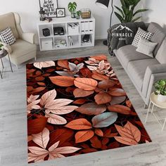 a living room area rug with red and brown leaves on it in front of a couch