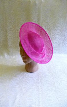 One contoured saucer with an upturned brim hat sinamay straw fascinator / hat base in fuchsia pink that measures approximately 12" (30.5 cm) in diameter. The base is contoured to fit against the head. The edges of the brim are finished in sinamay. The multi-layer stiffened sinamay straw has a great sturdy weave and provides excellent support for your millinery creations. This is NOT a ready to wear finished hat and it will not stay on your head unless you add a head band to wear. Add embellishments of your choice. Sinamay is a natural material and you may see some color striations in the weave. This is not a defect, but is the result of how different natural fibers respond to dye. A nice high quality base - I know you'll be pleased! This hat base is listed separately in navy, yellow, white Saucer Hat, Hat Form, Millinery Supplies, Hat Base, Spring Racing, Fascinator Hat, Diy Hat, Fashion Project, Fascinator Hats