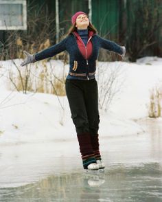 a woman is skating on an ice rink