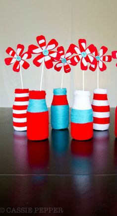 red, white and blue cupcake toppers on sticks with candy canes in them