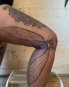 a person with tattoos on their legs and knees