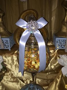 a glass jar filled with candy sitting on top of a table