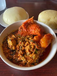 a bowl filled with food sitting on top of a wooden table