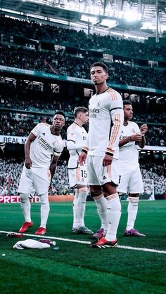 several soccer players are standing on the field