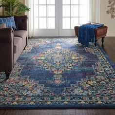 a living room area with couches and rugs