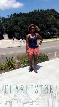 a woman standing on the sidewalk with her hands on her hips