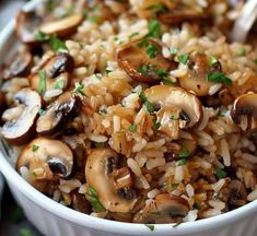 a white bowl filled with rice and mushrooms