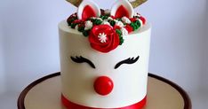 a white and red decorated cake with reindeer ears