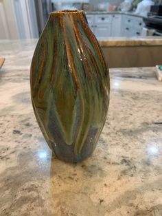 a vase sitting on top of a marble counter