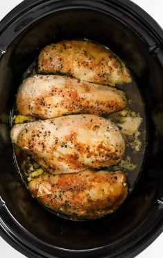 three pieces of chicken in a slow cooker