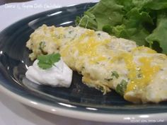 an omelet with lettuce and sour cream sits on a blue plate