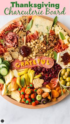 a platter filled with lots of different types of meats, cheese and vegetables