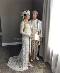 a man and woman dressed up in wedding attire