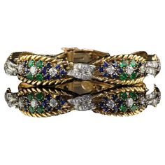 Beautiful Vintage Retro French 18K Yellow Gold Platinum Diamond Sapphire Emerald Bracelet. This incredible French Retro bracelet is crafted in 18k yellow gold and platinum. This bracelet features natural transitional cut diamonds, emeralds, and sapphires set in 18k yellow gold and platinum. The colored stones have a very deep saturation of colors and the bracelet looks incredible. The clasp on the bracelet locks flush into the bracelet and is stamped "Made in France". The bracelet is in great condition and very beautiful on the wrist. Item #B0094 Metal: 18K Yellow Gold and Platinum Weight: 47.2 Grams Size: 7 inches long Diamonds: Approximately 3.5 cts Color: H Clarity: VS2 Sapphires: Approximately 2 cts Emeralds: Approximately 2 cts Measurements: Top of the bracelet measures 12.9 mm wide a Luxury Vintage Jeweled Bracelets, Luxury Vintage Rectangular Bracelets, Beautiful Rings Vintage, Platinum Bracelet, Retro Bracelet, Emerald Bracelet, Sapphire Band, French Retro, Colored Stones