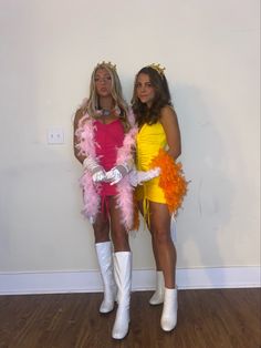 two women dressed in costumes standing next to each other