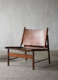 a leather chair sitting on top of a wooden table