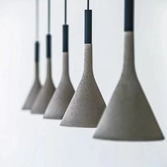 five cement pendant lights hanging from the ceiling