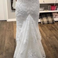 a woman in a wedding dress is taking a selfie with her cell phone as she stands in front of a mirror