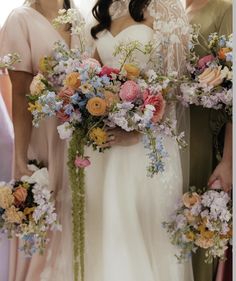 three bridesmaids holding bouquets of flowers in their hands