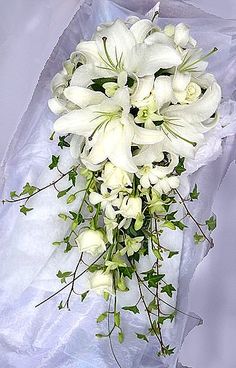 a bouquet of white flowers sitting on top of a table