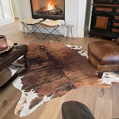 a living room with a cow hide rug