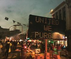 a large sign that reads united we are here