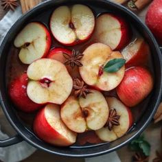 apples are in a pot with cinnamons and star anise