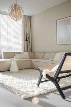 a living room with a couch, chair and rug