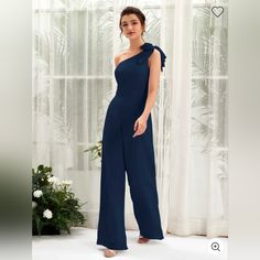 Navy Blue Multi Lined One Shoulder Jumpsuit. Left Side Zipper Enclosure With Bow Detail On Left Shoulder. Dart Seems On Front Of Bust For Accentuated Silhouette. Wide Legs. Elegant One-shoulder Blue Jumpsuits And Rompers, Elegant Blue One-shoulder Jumpsuit, Sleeveless Summer Jumpsuits And Rompers For Bridesmaids, Sleeveless Summer Bridesmaid Jumpsuits And Rompers, Chic Blue One-shoulder Jumpsuit, Red Joggers, Chiffon Jumpsuit, One Shoulder Jumpsuit, Pink Bodycon Dresses