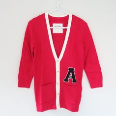 Abercrombie & Fitch - A&F Charlie Red White V Neck A Applique Cardigan Sweater S Brand: Abercrombie & Fitch Color: Red, White Condition: New With Tag Size: S Detail: Supersoft, V-Neck Cardigan With Varsity Letter Applique, Contrast Trim, Logo Engraved Button Closure, Front Patch Pockets, Ribbed Trim, Interior Neck Taping, Classic Fit, Imported 60% Cotton/35% Nylon/5% Angora [Sku: C34] Red V-neck Cotton Outerwear, White Fall Cardigan For College, Red Cotton V-neck Cardigan, White Cardigan For College In Fall, Classic Red Cotton Cardigan, Red College Sweater For Fall, Red Sweater For College In Fall, Letter Applique, Neck Taping