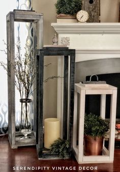 three wooden lanterns sitting on top of a hard wood floor next to a fire place