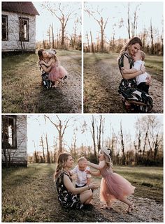 a woman holding a baby in her arms while sitting on the ground next to an old house