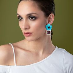 The Louise Earrings, adorned with semi-precious stones, offer a detachable bottom for a versatile styling option, allowing the flower studs to be worn independently. The drop section features pearl accents, adding elegance to its unique vintage and retro design. Chic Flower Shaped Jewelry With Matching Earrings, Turquoise Flower Jewelry For Party, Turquoise Gemstone Earrings For Party, Chic Flower-shaped Matching Earrings, Elegant Turquoise Earrings With Gemstone Accents, Chic Flower-shaped Jewelry With Matching Earrings, Chic Flower-shaped Matching Earrings Jewelry, Elegant Turquoise Drop Flower Earrings, Elegant Turquoise Flower Drop Earrings