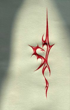 a red tattoo design on white paper with shadow from the sun shining through its center